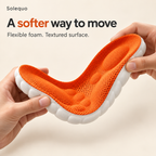 Hands gently bending the orange and white foam insole