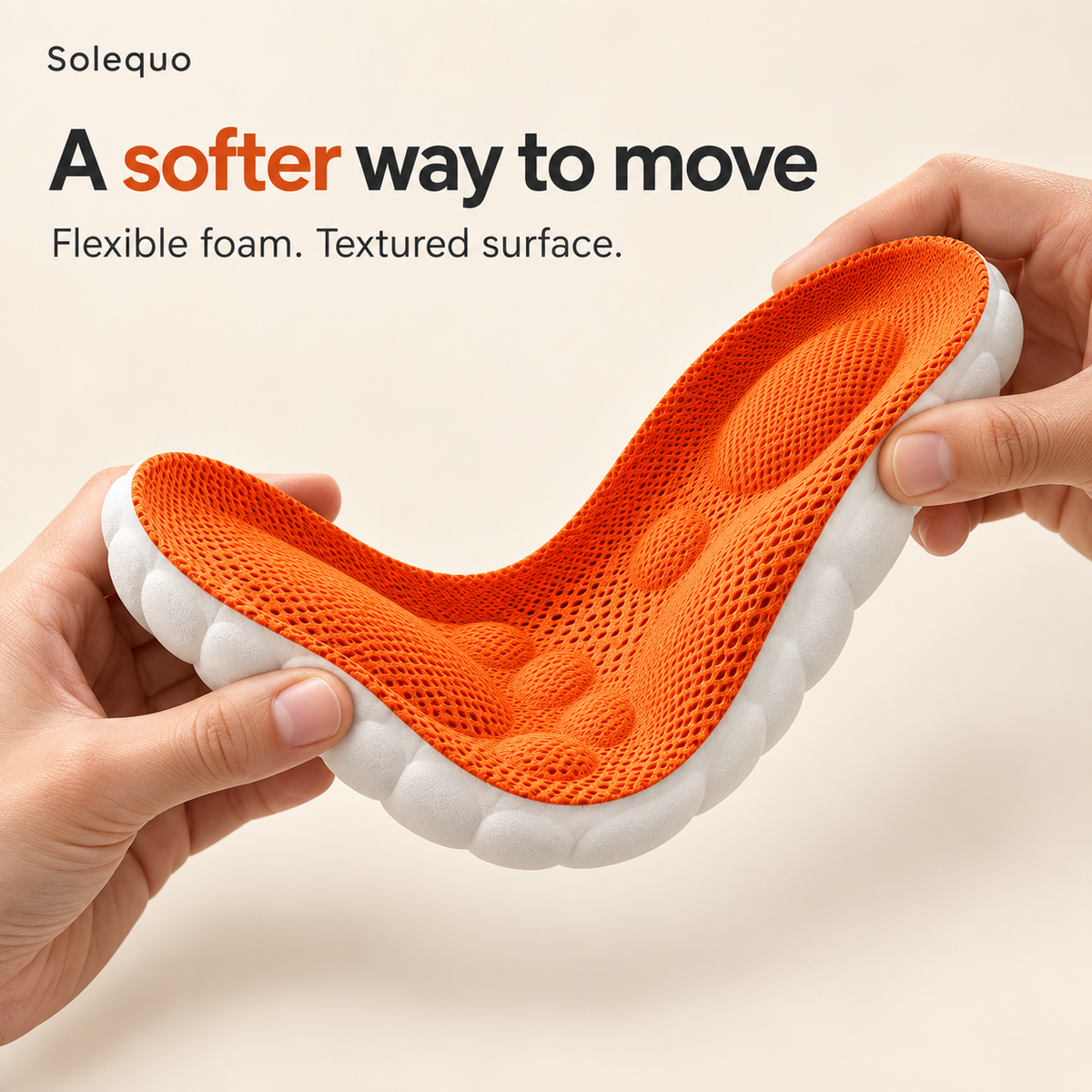 Hands gently bending the orange and white foam insole